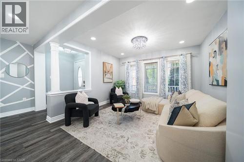 Living area featuring wood-finish flooring, recessed lighting, and a decorative chandelier - 151 Baldwin Drive, Cambridge, ON - Indoor