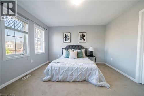 Light gray walls complemented by two large windows with blinds - 151 Baldwin Drive, Cambridge, ON - Indoor Photo Showing Bedroom
