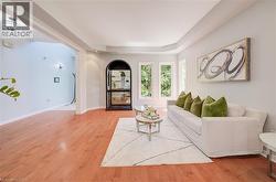 Hardwood-finish flooring extending into an open living area with multiple windows - 