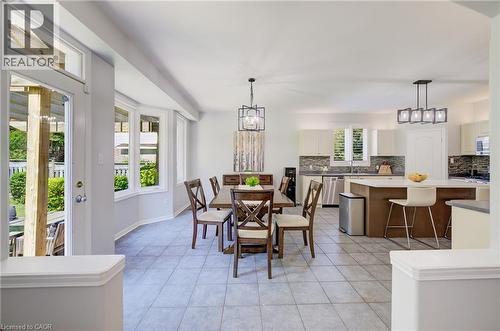 Open-concept living space featuring light gray tile flooring and a bay window - 23 Buerkle Court, Kitchener, ON - Indoor Photo Showing Dining Room