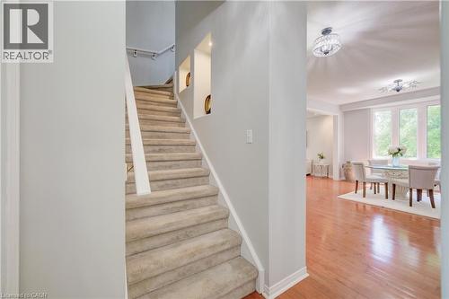 Carpeted staircase with built-in wall niches and a white handrail - 23 Buerkle Court, Kitchener, ON - Indoor