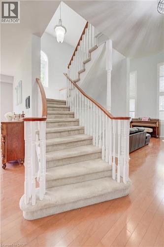 Carpeted staircase with white balusters and wood handrails - 23 Buerkle Court, Kitchener, ON - Indoor Photo Showing Other Room