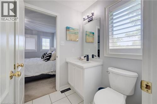 White vanity with a solid surface countertop and undermount sink - 23 Buerkle Court, Kitchener, ON - Indoor Photo Showing Bathroom