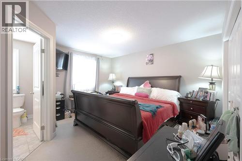 Bedroom featuring a textured ceiling and light colored carpet - 535 Margaret Street Unit# 74, Cambridge, ON 