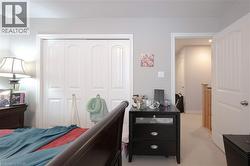 Carpeted bedroom featuring a closet - 