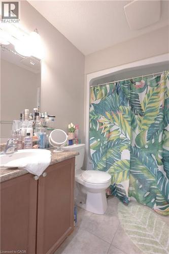 Bathroom featuring vanity, a shower with curtain, light tile patterned floors, and a textured ceiling - 535 Margaret Street Unit# 74, Cambridge, ON 