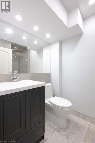 Bathroom featuring vanity, a stall shower, light tile patterned flooring, and recessed lighting - 535 Margaret Street Unit# 74, Cambridge, ON 
