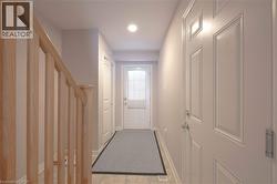 Doorway to outside with stairway, tile patterned floors, and recessed lighting - 