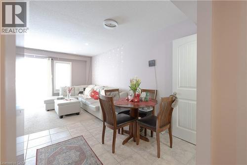 Dining space featuring a textured ceiling, light tile patterned flooring, and light carpet - 535 Margaret Street Unit# 74, Cambridge, ON 