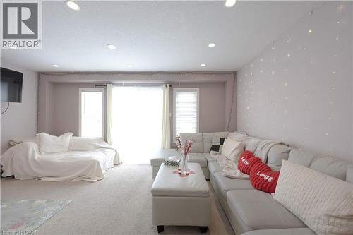 Carpeted living area featuring a textured ceiling and recessed lighting - 535 Margaret Street Unit# 74, Cambridge, ON 