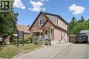 Brick exterior featuring a covered front porch with white railings and an awning - 75 Arnold Street, Kitchener, ON  - Outdoor With Facade 