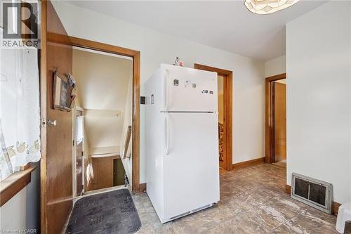Interior space featuring warm-toned wood trim, light-colored walls, and patterned flooring - 75 Arnold Street, Kitchener, ON - Indoor