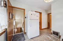 Interior space featuring warm-toned wood trim, light-colored walls, and patterned flooring - 