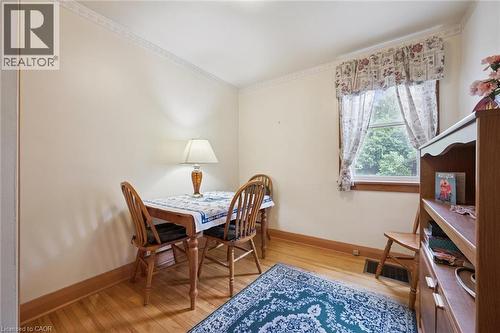 Hardwood flooring with natural wood trim and crown molding - 75 Arnold Street, Kitchener, ON - Indoor Photo Showing Dining Room