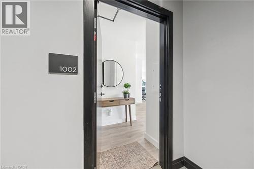 Entryway with dark trim framing the doorway, light wood-finish flooring, and a decorative console table - 50 S Grand Avenue S Unit# 1002, Cambridge, ON - Indoor Photo Showing Bathroom