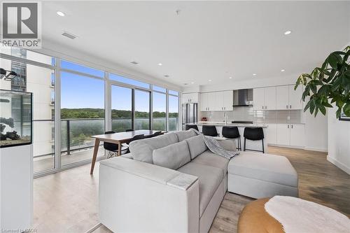 Open-concept living space with expansive wall-to-wall windows, light wood-finish flooring, and recessed lighting - 50 S Grand Avenue S Unit# 1002, Cambridge, ON - Indoor Photo Showing Living Room