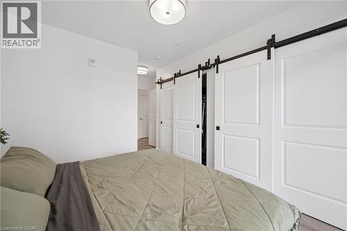 Interior space featuring white walls and wood-finish flooring - 50 S Grand Avenue S Unit# 1002, Cambridge, ON - Indoor Photo Showing Bedroom