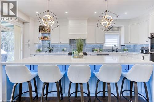 Central kitchen island featuring a light-colored countertop and a blue base with under-cabinet lighting - 71 Ian Ormston Drive, Waterloo, ON 