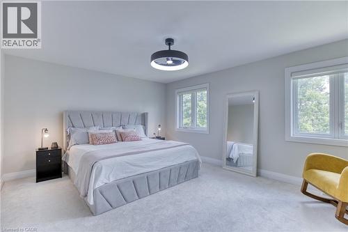 Bright bedroom with plush carpeting and light-toned walls - 71 Ian Ormston Drive, Waterloo, ON 
