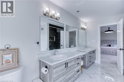 Double vanity with light wood-finish cabinetry and white countertops - 71 Ian Ormston Drive, Waterloo, ON 