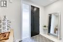 Modern entry featuring a paneled door with long pulls, a textured sidelight, and light-toned flooring - 71 Ian Ormston Drive, Waterloo, ON 