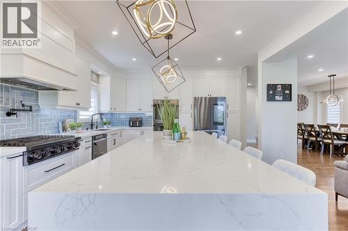 Expansive kitchen island featuring a quartz countertop and integrated seating - 71 Ian Ormston Drive, Kitchener, ON - Indoor Photo Showing Kitchen With Upgraded Kitchen