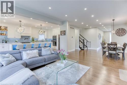 Open-concept main living area with wood-finish flooring throughout - 71 Ian Ormston Drive, Kitchener, ON - Indoor Photo Showing Living Room