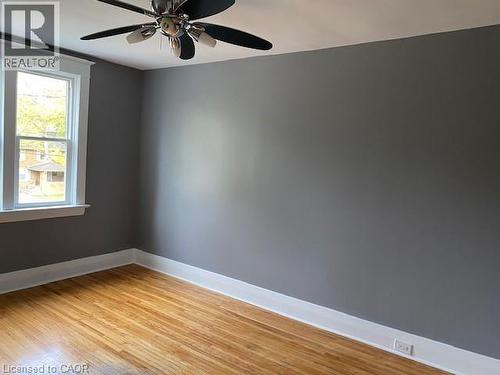 Hardwood flooring, neutral gray wall paint, and white trim - 1066 Richmond Street, London, ON 