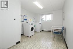 Utility room with patterned flooring, white walls, and a window providing natural light - 