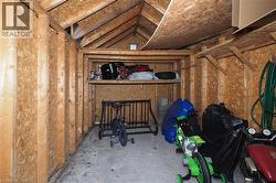 Interior storage structure featuring exposed wood framing, oriented strand board walls, and a concrete floor - 