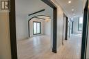 Hallway of the main floor w/living/dining on left - 32 Catterick Crescent, Ottawa, ON 