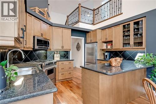 Kitchen is tucked in behind the fireplace - 4285 Couples Crescent, Burlington, ON - Indoor Photo Showing Kitchen With Double Sink With Upgraded Kitchen