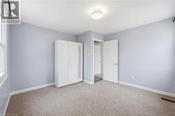 Unfurnished bedroom with carpet flooring and a closet - 