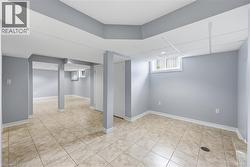 Below grade area featuring baseboards and light tile patterned floors - 