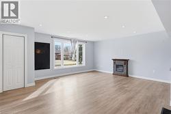Unfurnished living room with a fireplace, light wood-style floors, and recessed lighting - 