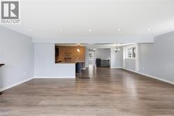 Unfurnished living room featuring light wood finished floors and recessed lighting - 