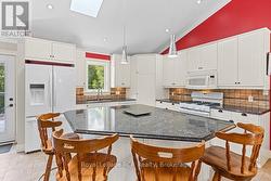 Modern open kitchen with island & walk-in pantry. - 