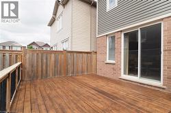 Spacious wood deck with a privacy fence - 