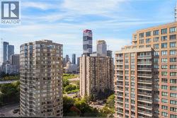 Cityscape featuring multiple high-rise buildings and a partial green space - 