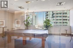 Recreation room featuring a pool table, expansive windows, and durable flooring - 