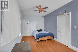 Wood-finish flooring throughout, complemented by light blue walls - 