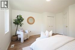 Spacious interior featuring wood-finish flooring, light-colored walls, a window with white trim, a six-panel door, and a bi-fold closet door - 