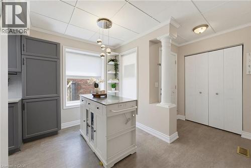 Kitchen featuring a central island, grey cabinetry, a window with roller shade, built-in shelving, and recessed lighting - 520 Mayflower Street, Waterloo, ON - Indoor