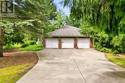 Three Car Garage Accommodates up to Four Vehicles - 