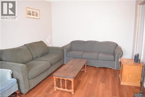 Spacious room featuring light-toned walls and wood-finish flooring - 249 Cedarbrae Avenue Unit# 1, Waterloo, ON 