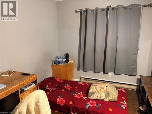 Interior room featuring light gray walls, a window with a curtain rod, and a baseboard heater - 249 Cedarbrae Avenue Unit# 1, Waterloo, ON 