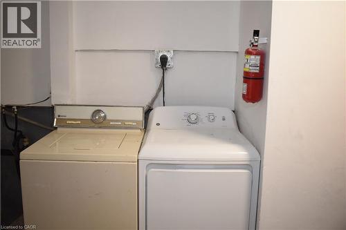 Dedicated laundry area featuring a white electric dryer and a beige top-load washing machine - 249 Cedarbrae Avenue Unit# 1, Waterloo, ON 