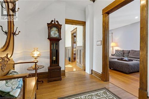 Hardwood flooring throughout the entry, framed by substantial wood door casings and baseboards - 630 Lawrence Street, Cambridge, ON - Indoor Photo Showing Other Room