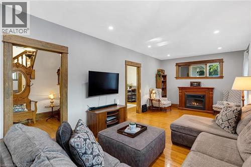 Living area featuring wood-finish flooring, recessed lighting, and light grey wall tones - 630 Lawrence Street, Cambridge, ON - Indoor Photo Showing Living Room With Fireplace