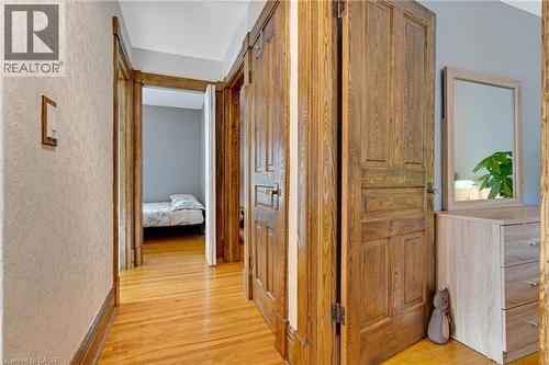 Hardwood flooring extending through the hallway, featuring solid wood doors and ornate door frames - 630 Lawrence Street, Cambridge, ON - Indoor Photo Showing Other Room
